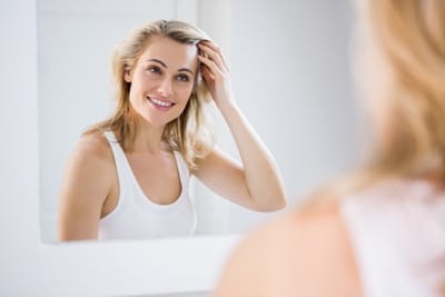 woman looking in the mirror