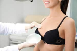 Doctor,Showing,Silicone,Implant,For,Breast,Augmentation,To,Patient,In