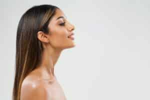 A profile shot of a woman after rhinoplasty surgery