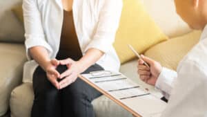 A cropped shot of a doctor talking to a woman about ThermiVa vaginal tightening