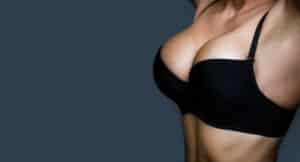 A close-up shot of a woman in a black bra after breast augmentation in Norman, OK