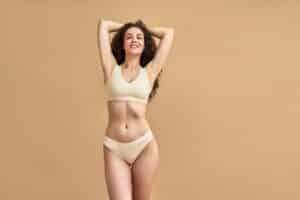A woman posing in beige underwear after ThermiVa® in Norman, OK