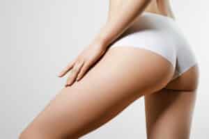 A close-up shot of a doctor marking a woman's eye for blepharoplasty in Norman, OK A close-up shot of a woman's thighs after a thigh lift in Edmond, OK